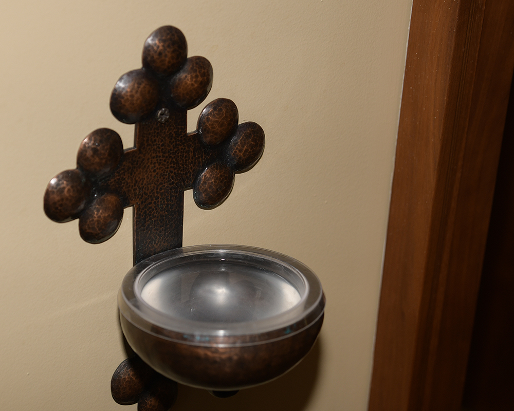 A holy water dispenser in the chapel