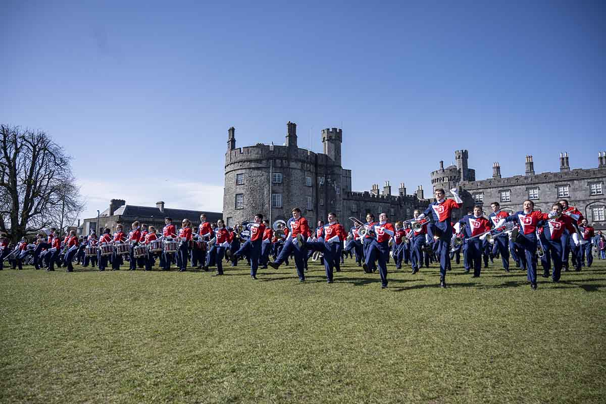 Pride of Dayton rehearses before the big parade one the lawn of a castle.
