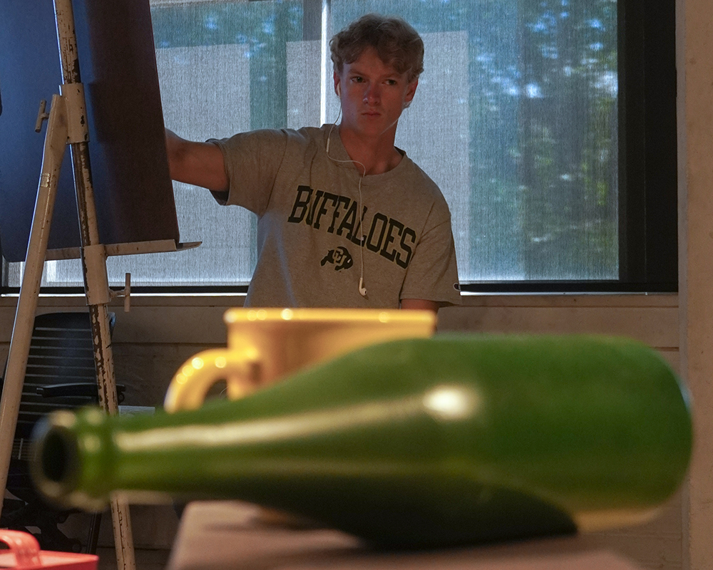 A green glass bottle provides s subject for a still life portrait