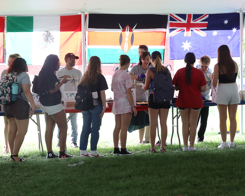 Students stand in line to sample foods from different countries