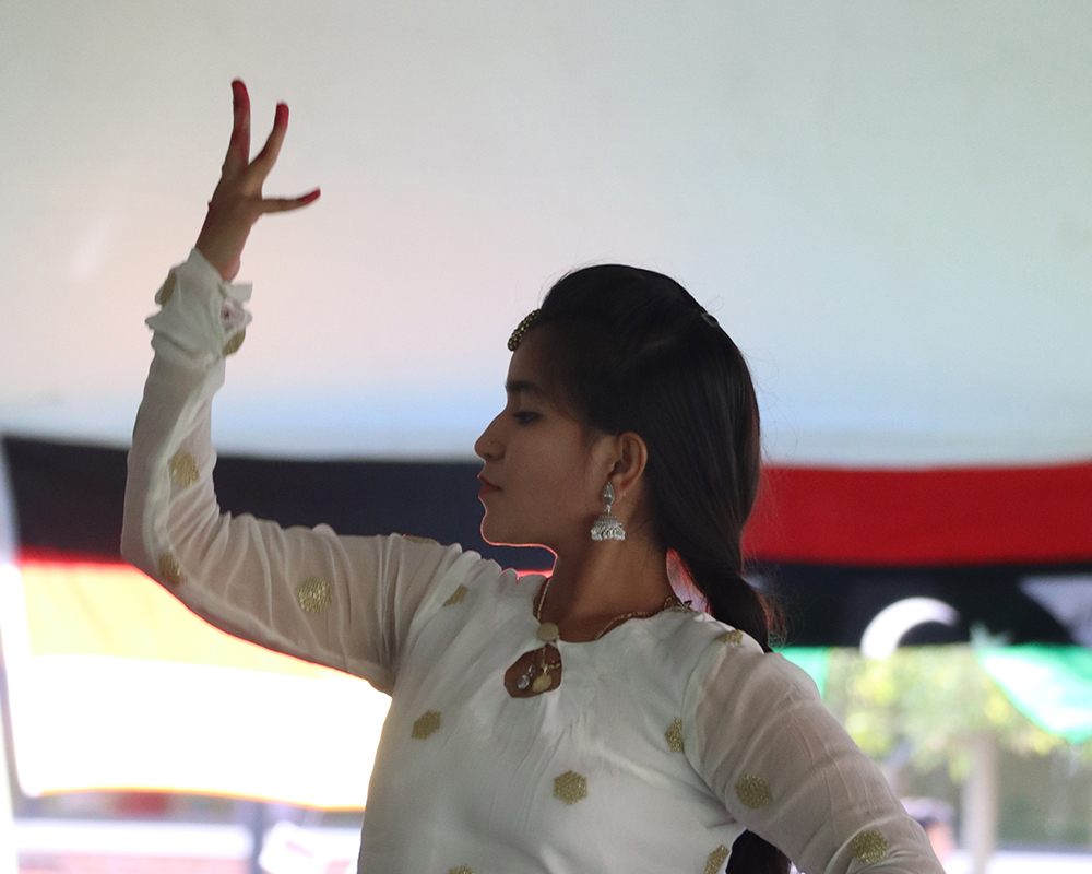 An Indian dancer performs for students