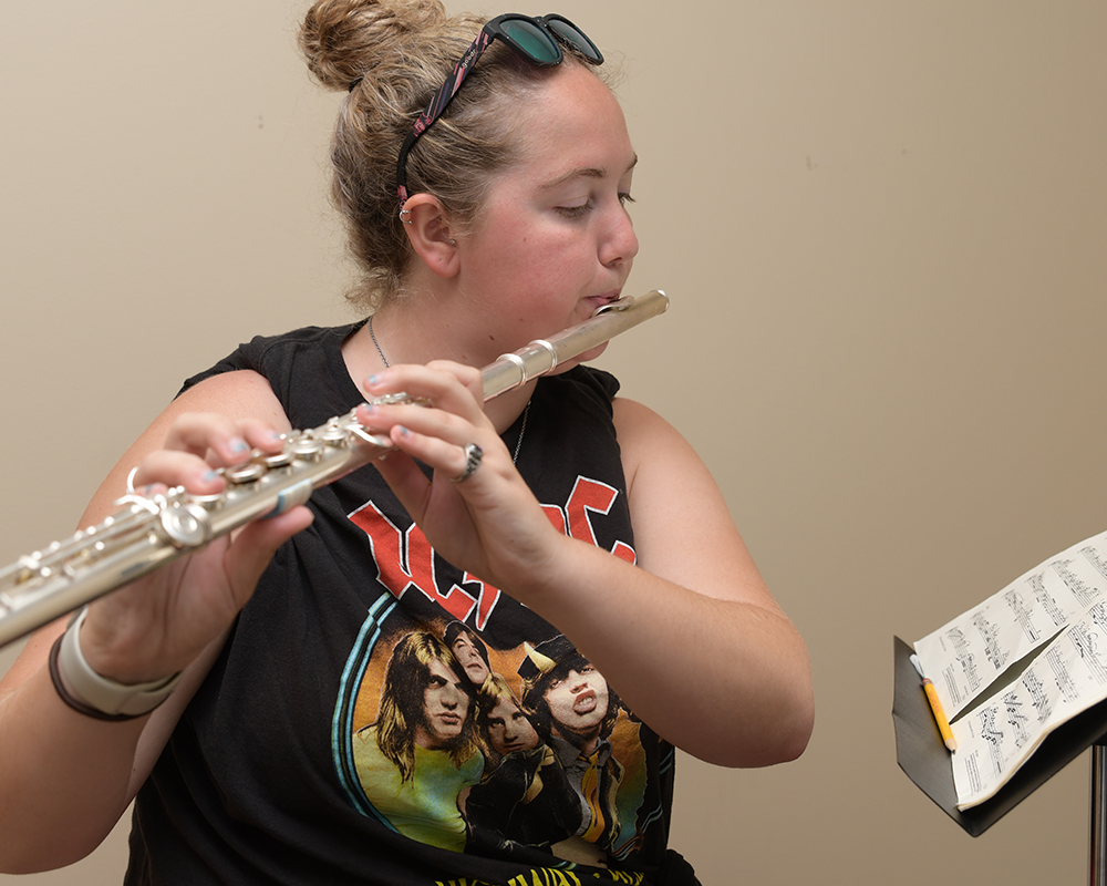 A music student practices the flute