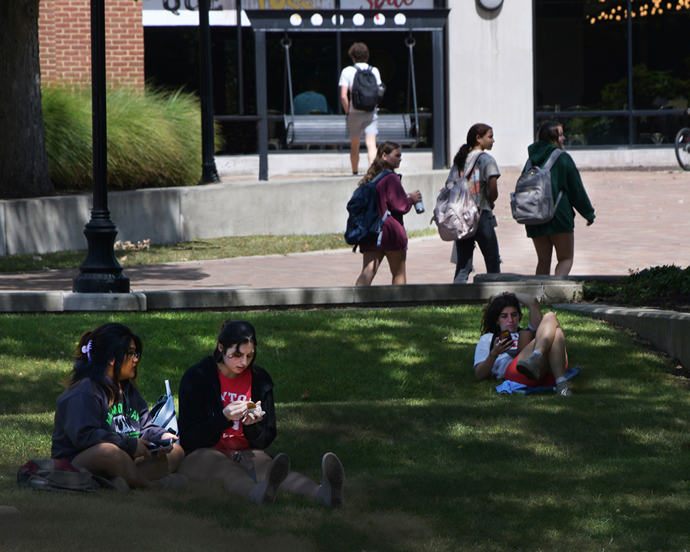 Students relax in the grass outside of Kennedy Union