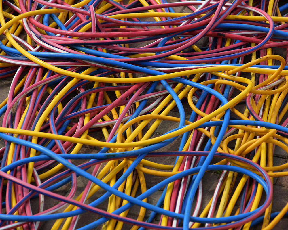 A pile of electrical cords in various bright colors