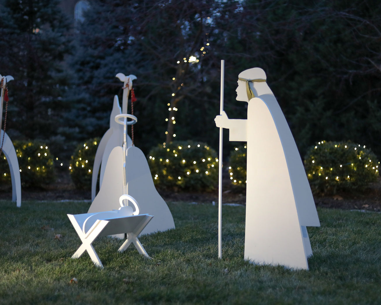 An illuminated nativity set is located near the chapel.