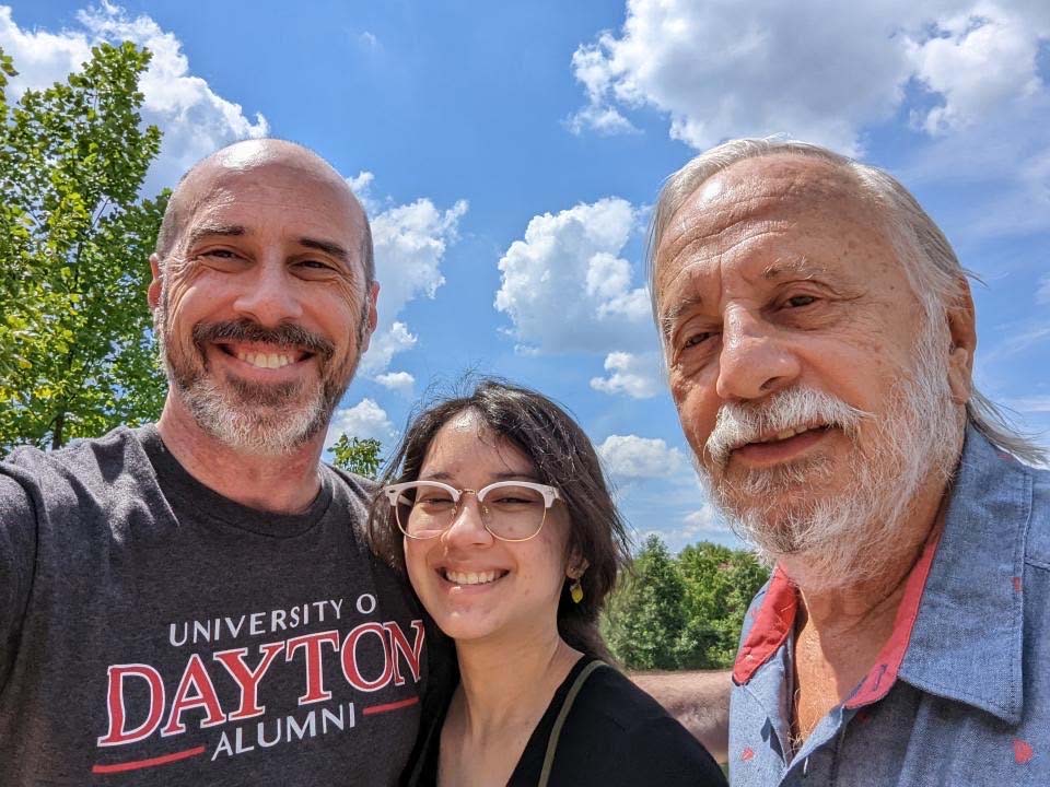 Three generations of Flyers pose together on campus.
