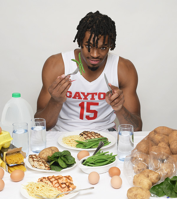 DaRon Holmes gets ready to eat green beans on his fork.
