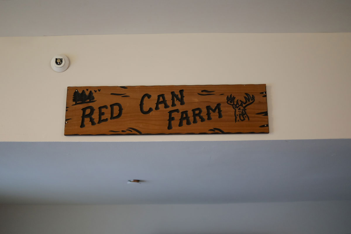 A wooden sign that reads Red Can Farm.