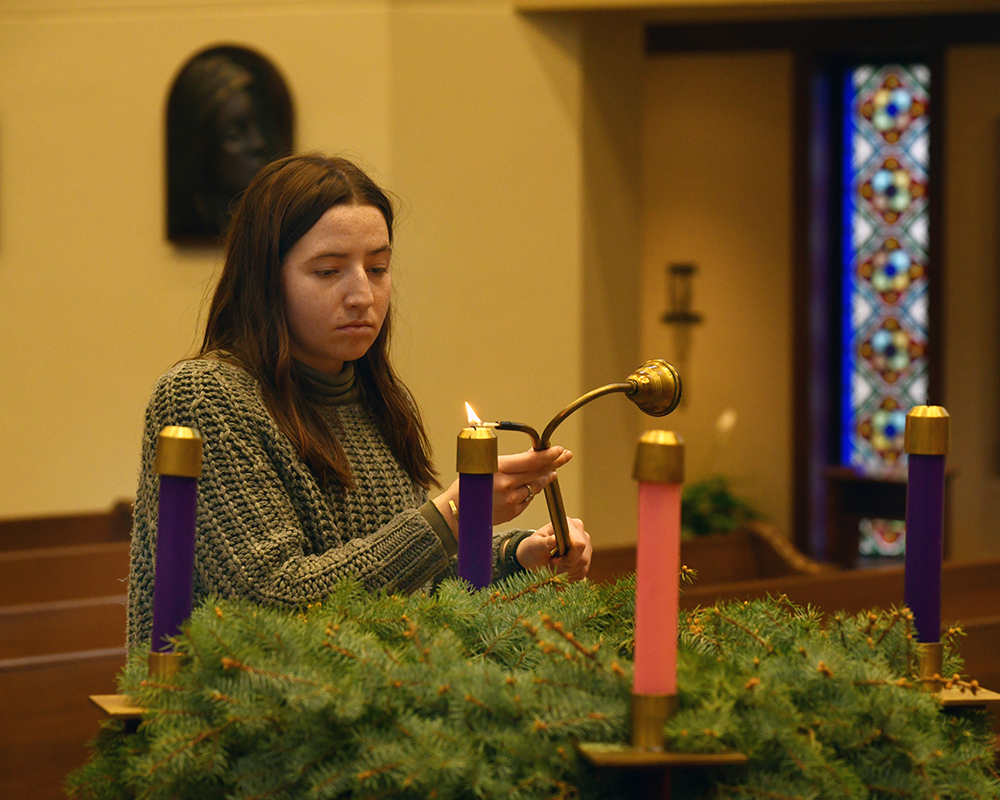 A woman lights an Advent wreath
