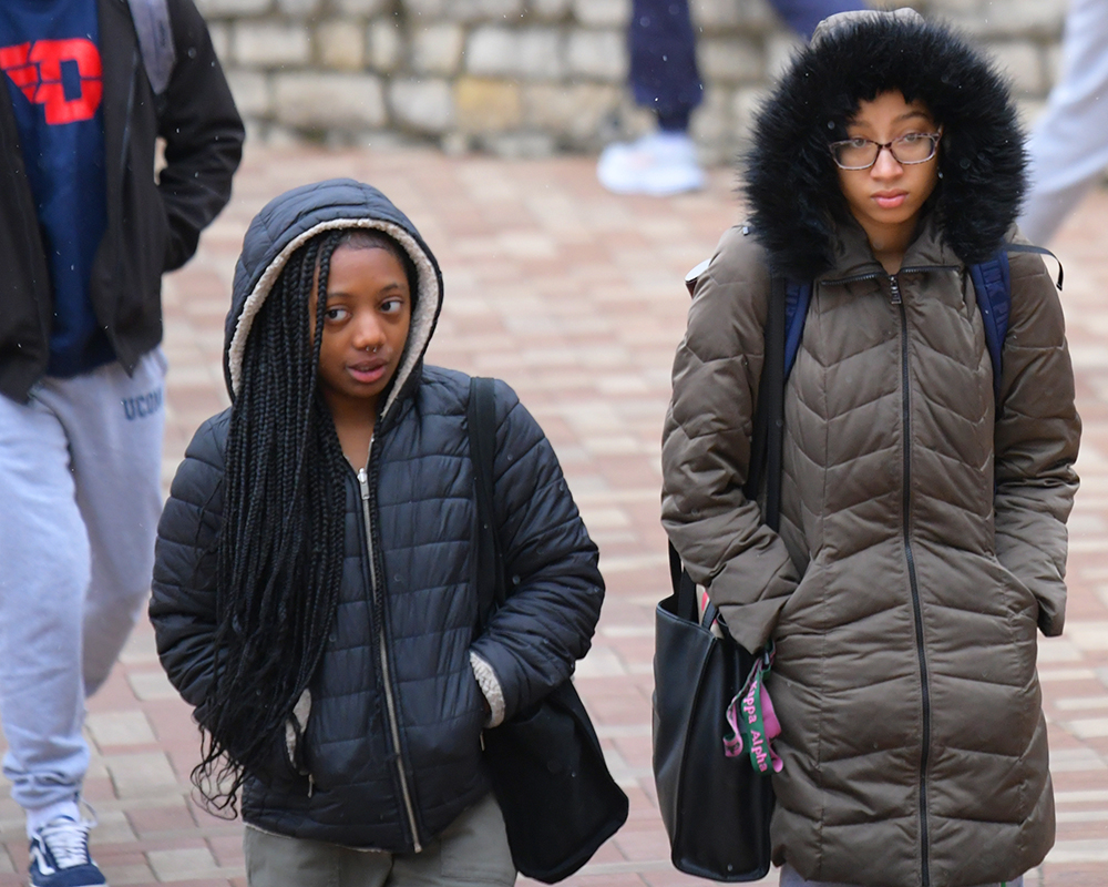 Students bundled in warm coats, walking to morning classes