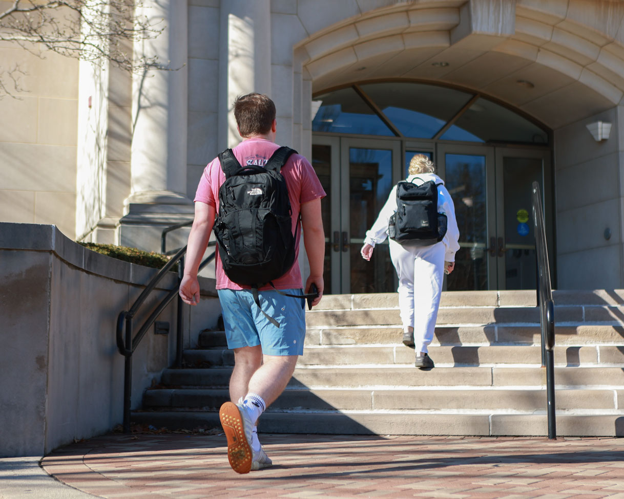 Two students approach the main entrance to Humanities