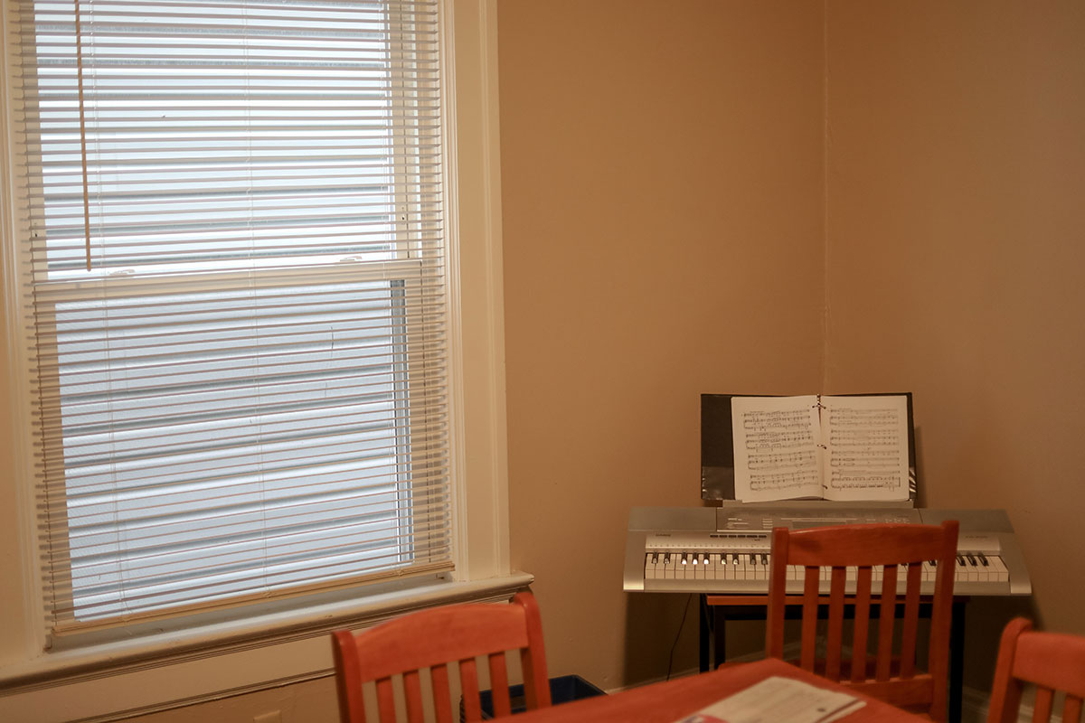 A keyboard sits in the corner of the dining room.