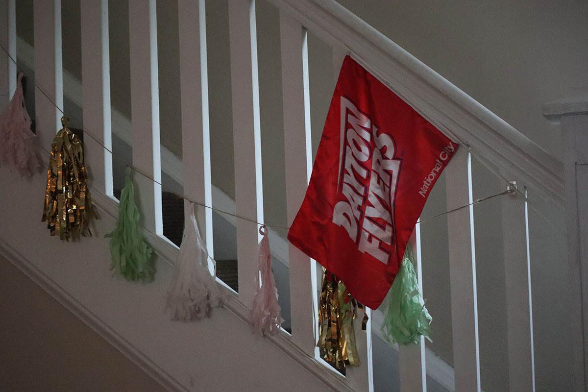 A Dayton Flyers flag as well as sparkling tassels hang from the stair railing.