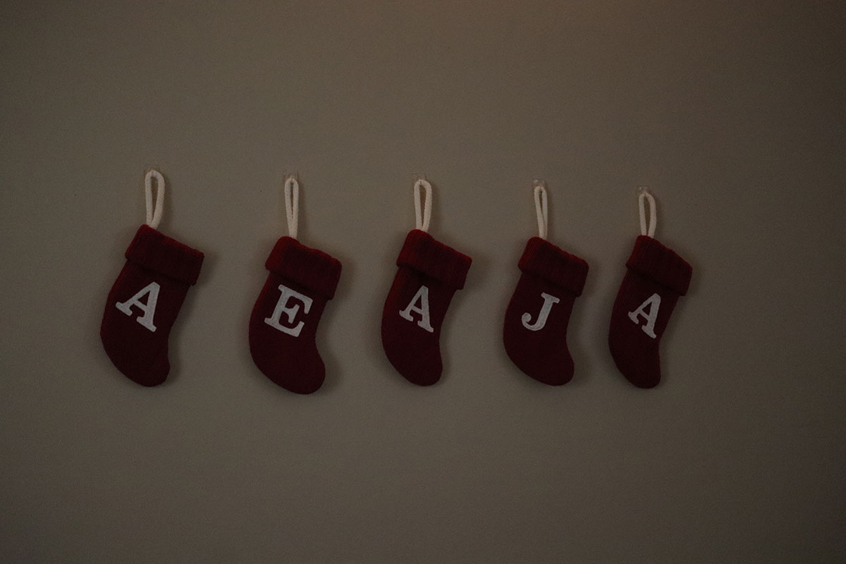 Stockings with the first initials of the housemates hang on the wall.