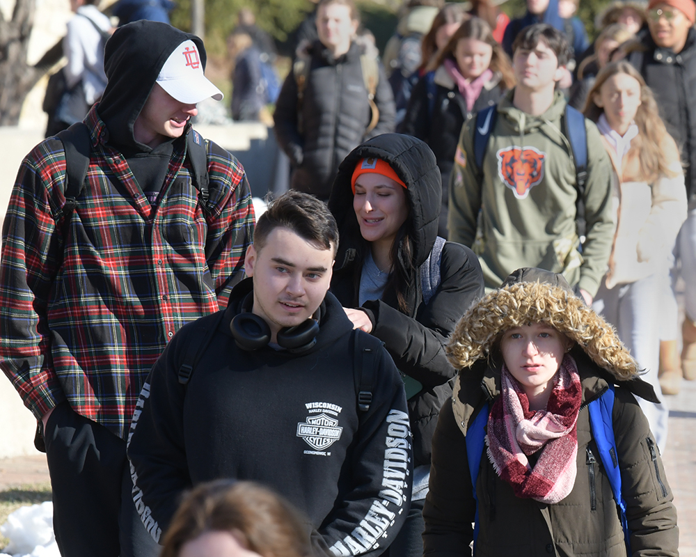 Students walk to class outdoors on a winter day