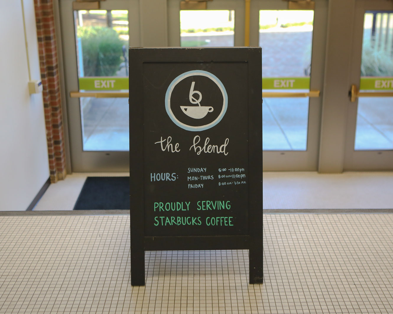 A sign advertising The Blend sits in a stairway in Roesch Library
