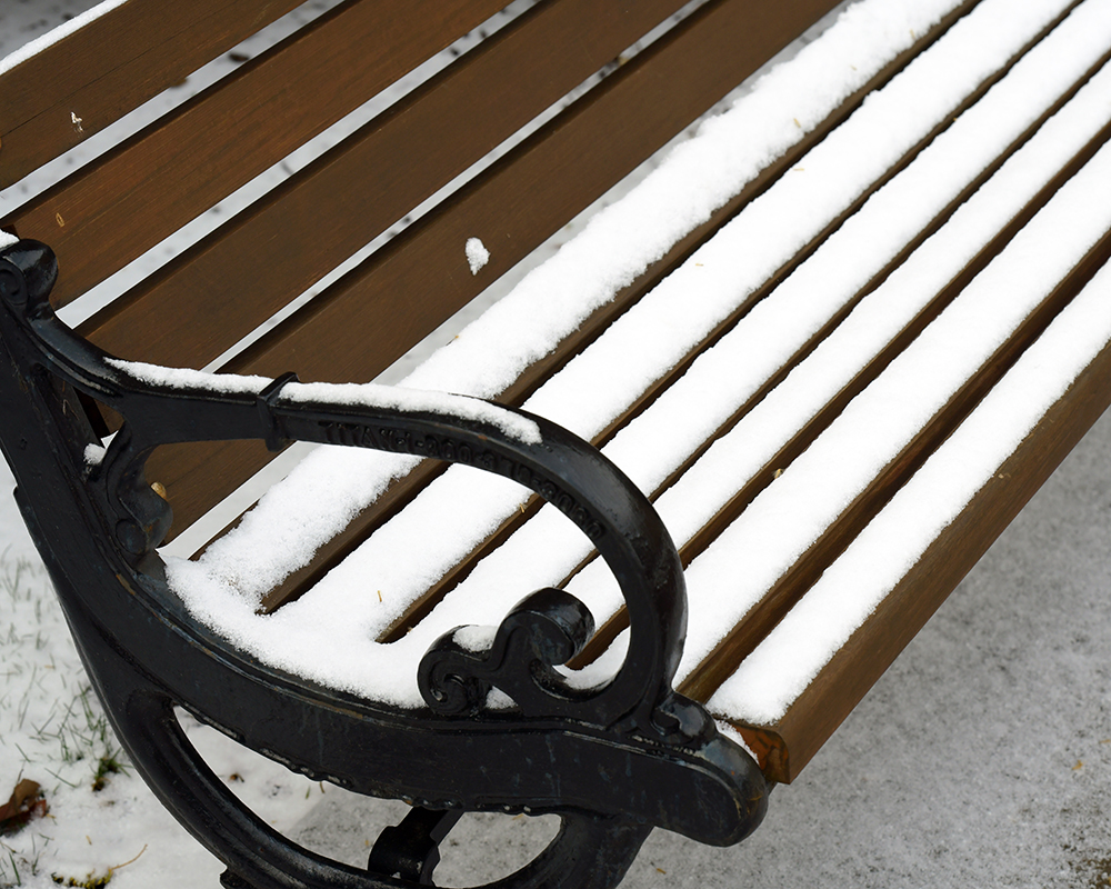 A snow covered bench