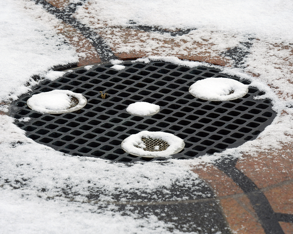 Snow on an outdoor drain cover
