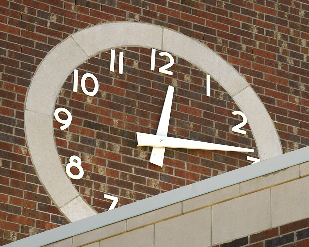 A clock built into the brick of a building exterior