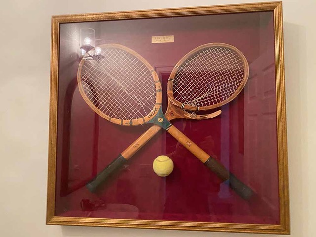 Old tennis rackets in a display case
