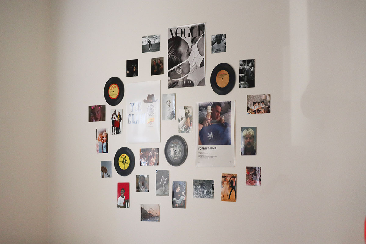 A collage of pictures, vinyl records and posters on the wall. 