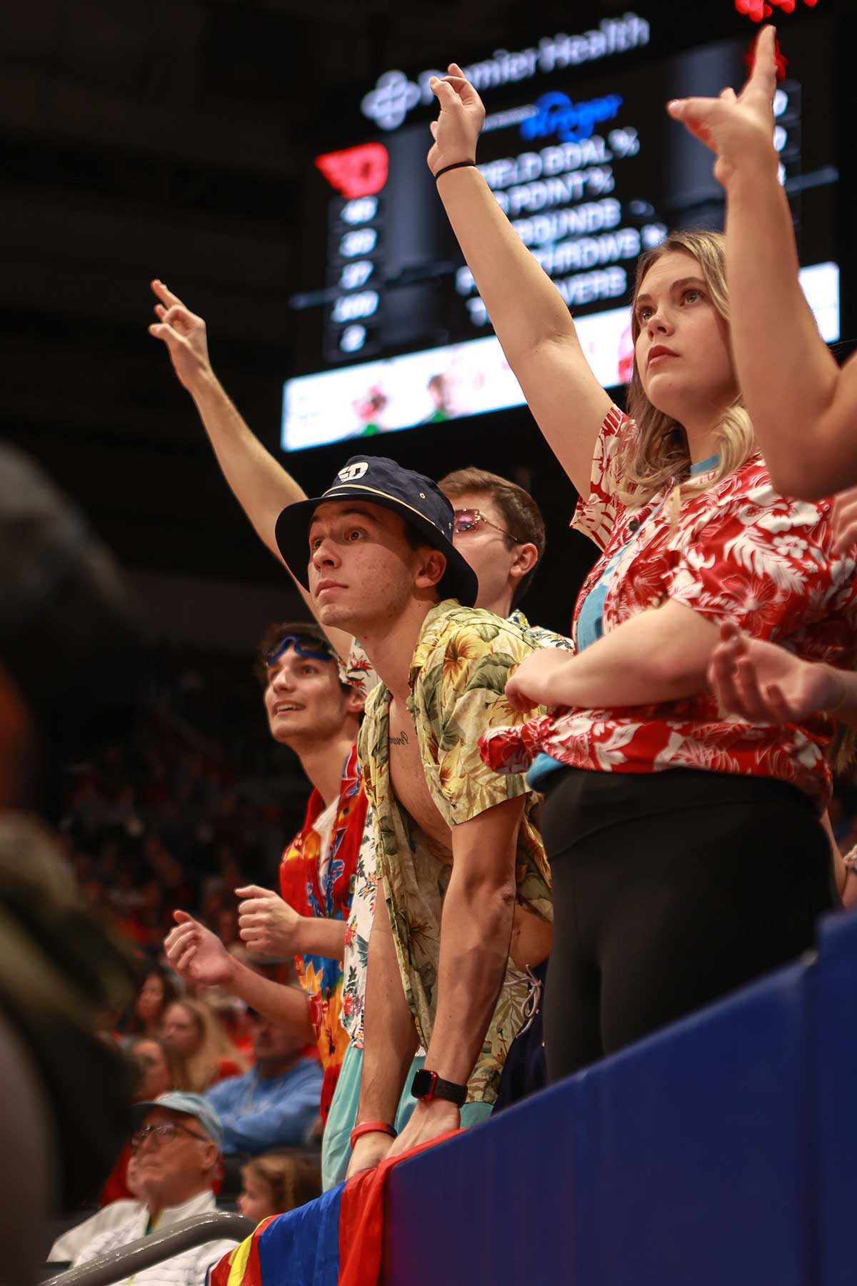Students dressed in Hawaiian shirts looking intently.