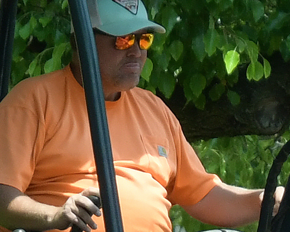 Close up of shiny orange sunglasses on equipment operator