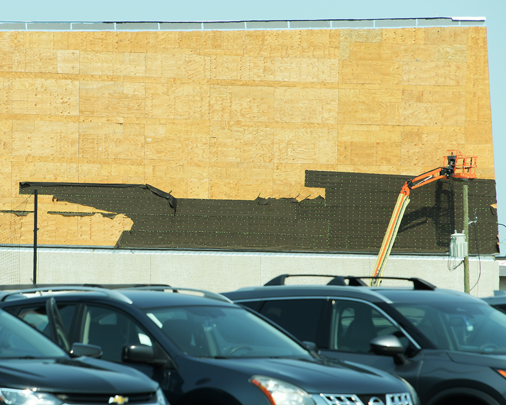 Outline of the hull of a ship in tar paper on Roger Glass Center for the Arts
