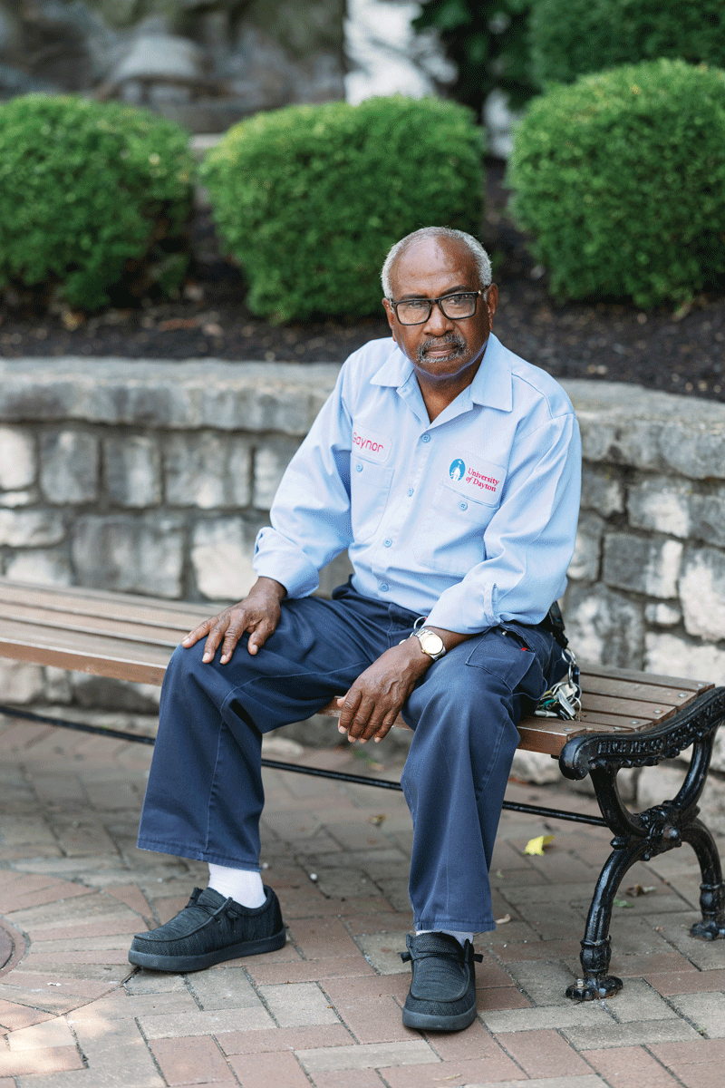 Portrait of Gaynor Payne sitting on a campus bench