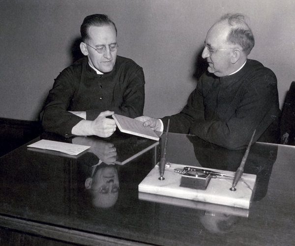 photo of Elbert handing first book to Monheim