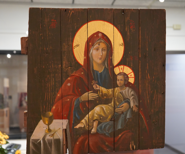 piece of wooden ammunition box with hand painted Mary and child Jesus icon
