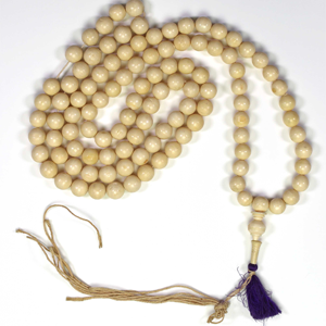 beige mala beads with a purple tassle