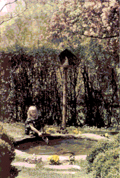 little girl playing in water in garden