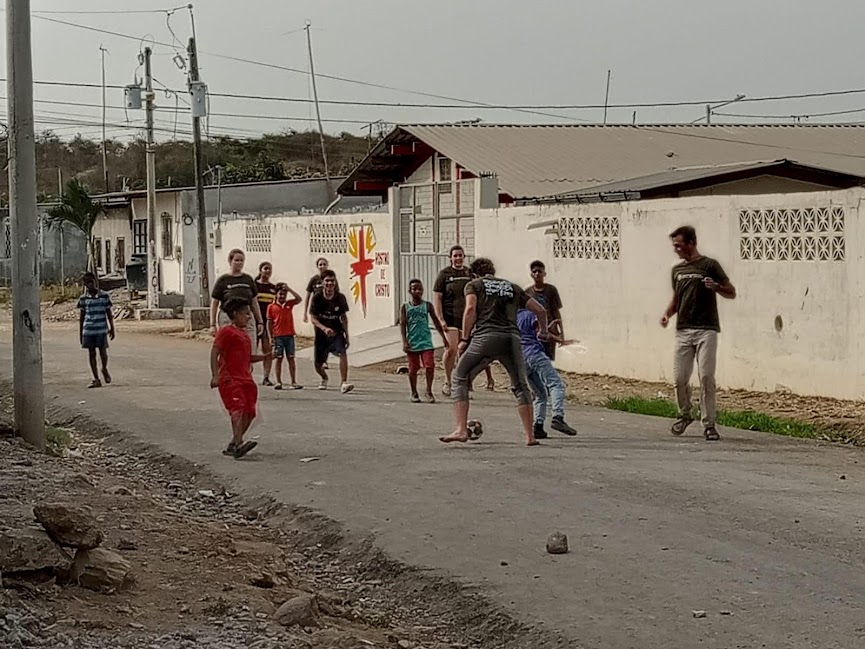 Rostro volunteers playing soccer with the neighbor kids