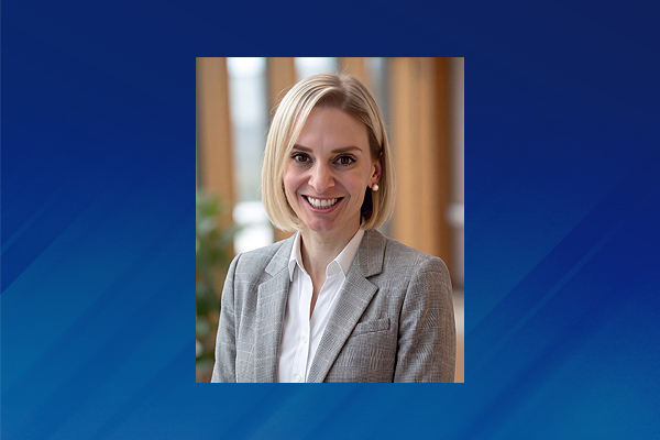 Professional headshot of Lindsay Girardin on blue graphic background