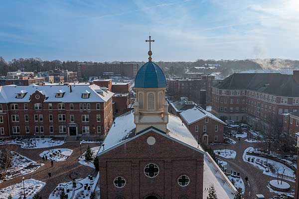 Aerial photo of Chapel of the Immaculate Conception and adjacent courtyards in the snow