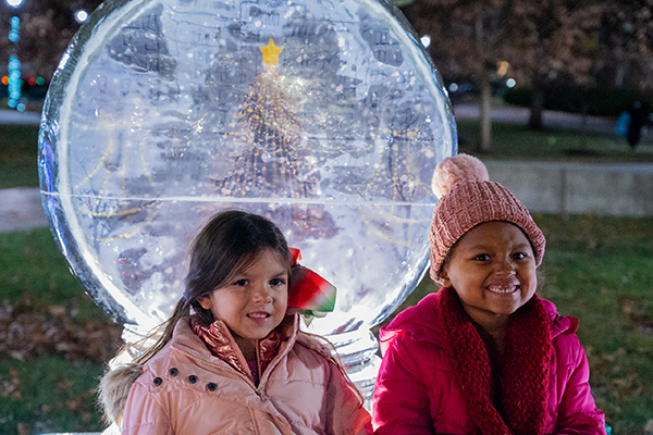 Children in front of ice sculpture at Christmas on Campus