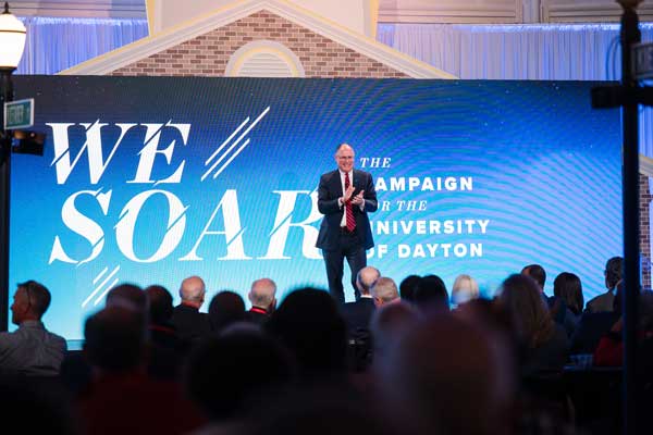 UD President Eric Spina in front of We Soar background to announce campaign