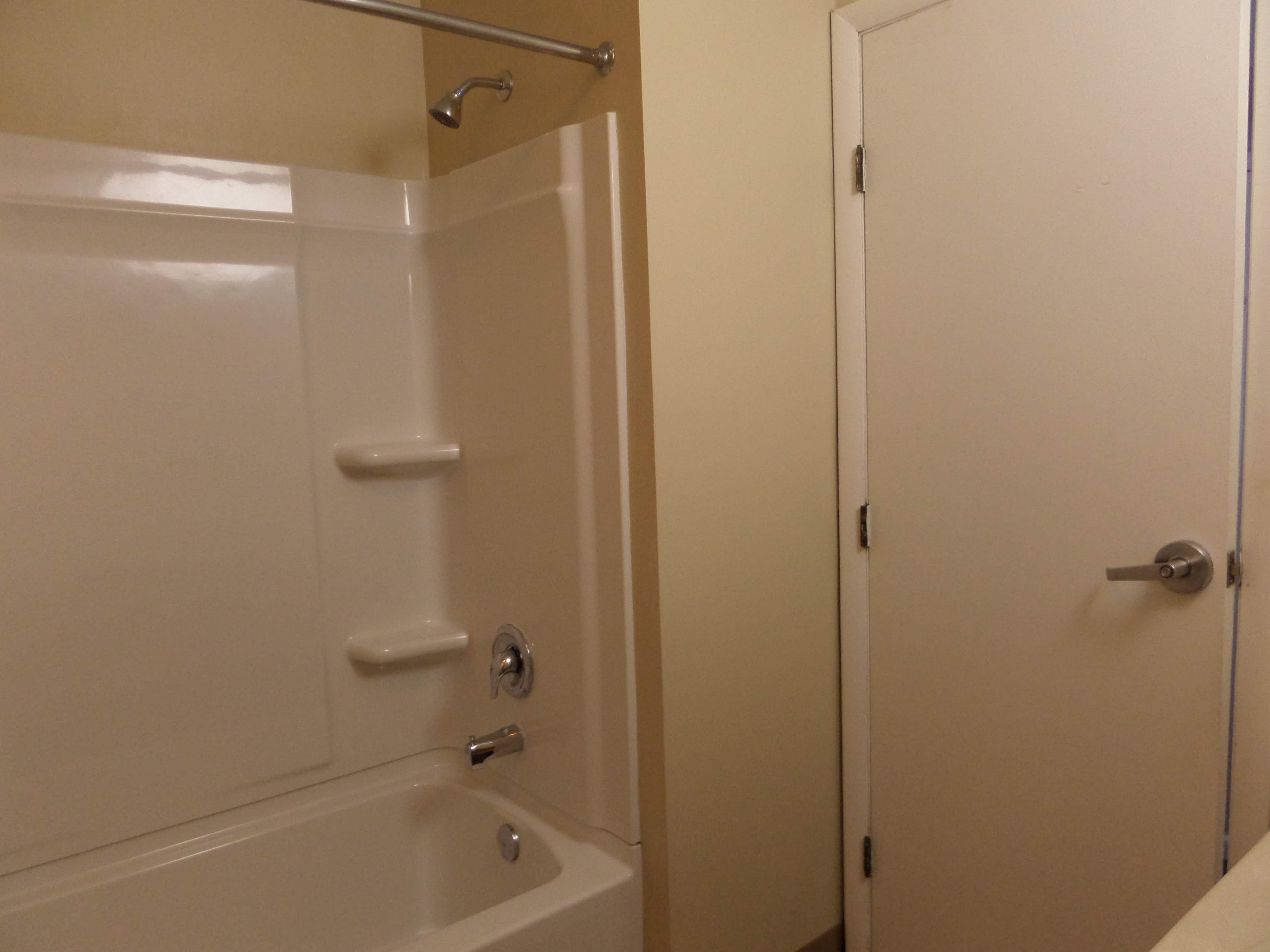 Shared bathroom with standard shower rail 