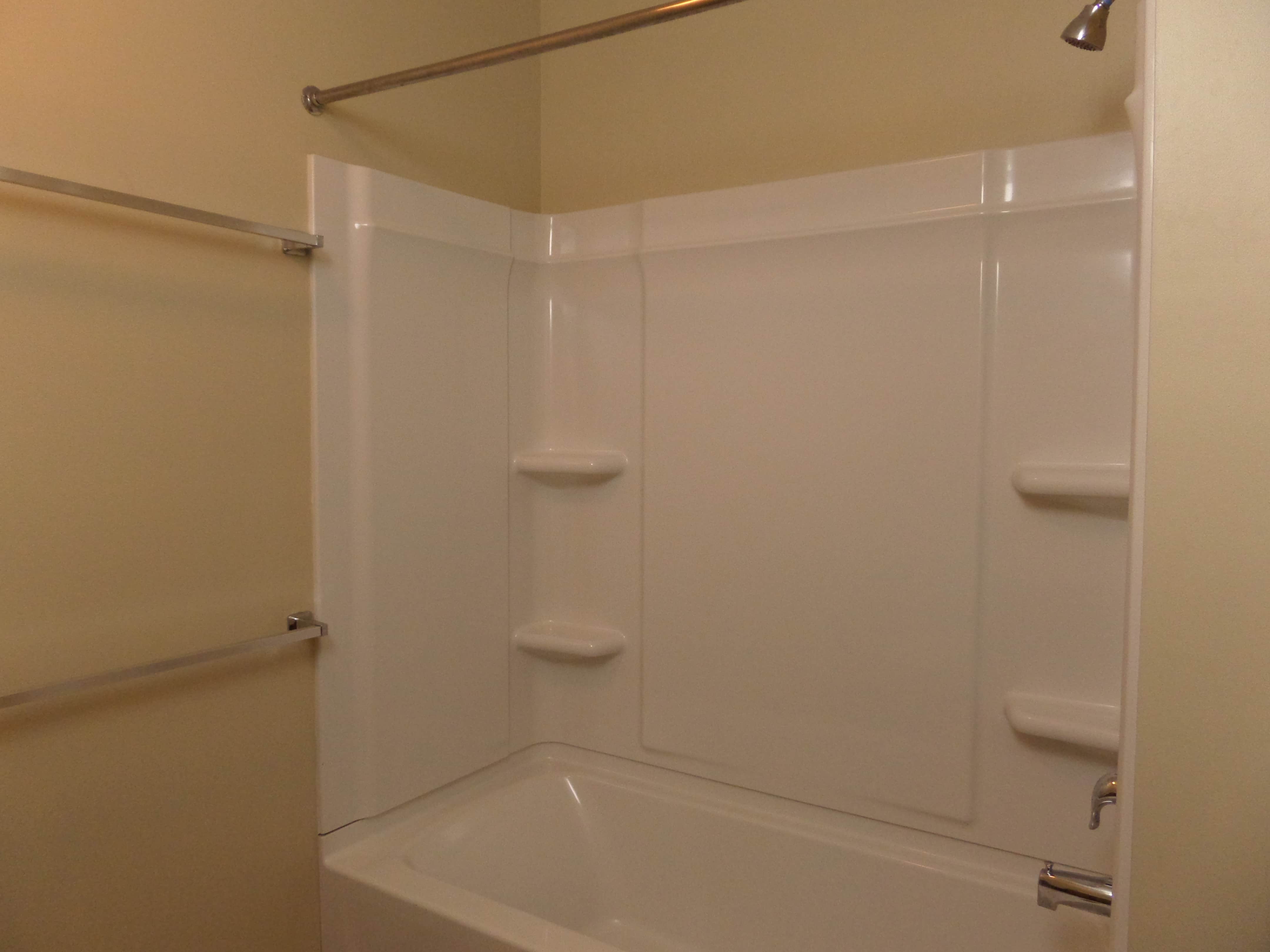 Bath has built-in shelves and towel rails 
