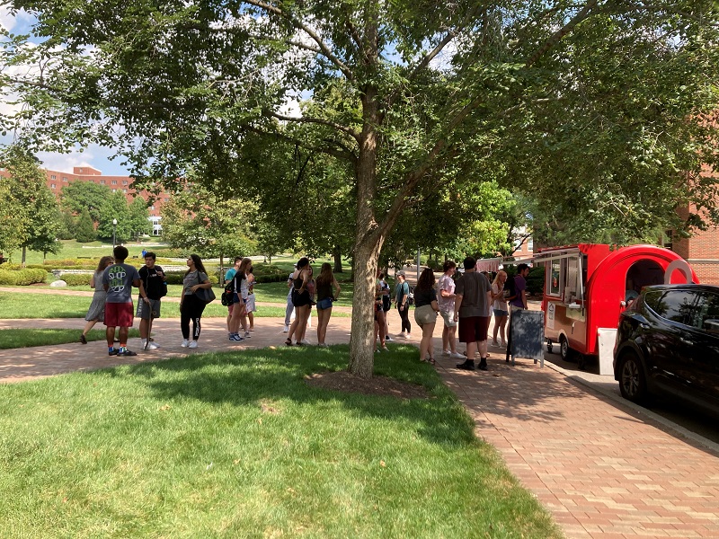 People waiting in line at an Ice Cream Truck
