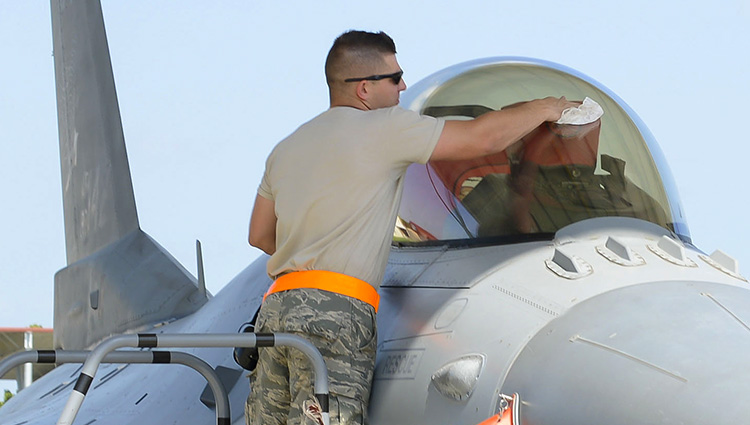 Staff Sgt. Cody Brown, 138th Maintenance Squadron, polishes the canopy of an F-16 fighter jet as part of the post-flight procedures on July 13, 2016 at the 138th Fighter Wing.