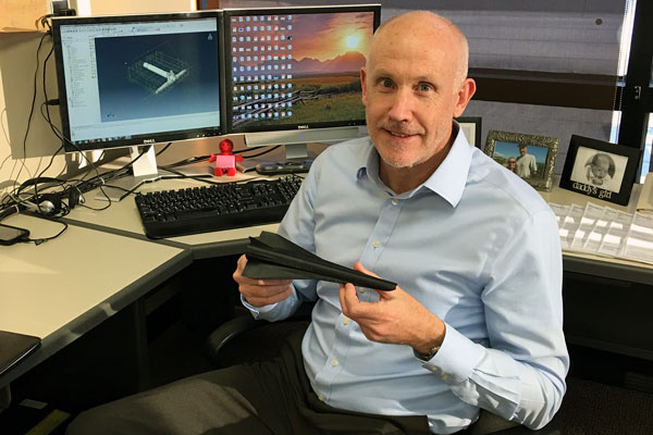 UDRI's Dr. Steve Olson holds a model of a hypersonic aircraft.