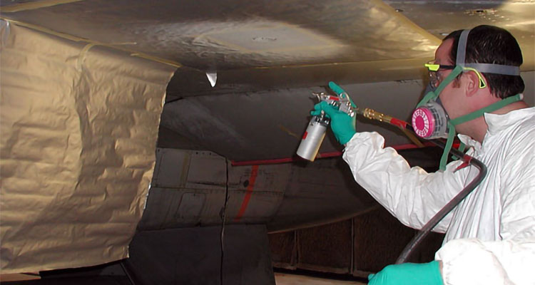 UDRI researcher Dan McCray primes an aircraft wing during repair.