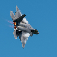A US Air Force F-22 banks to the right while in flight