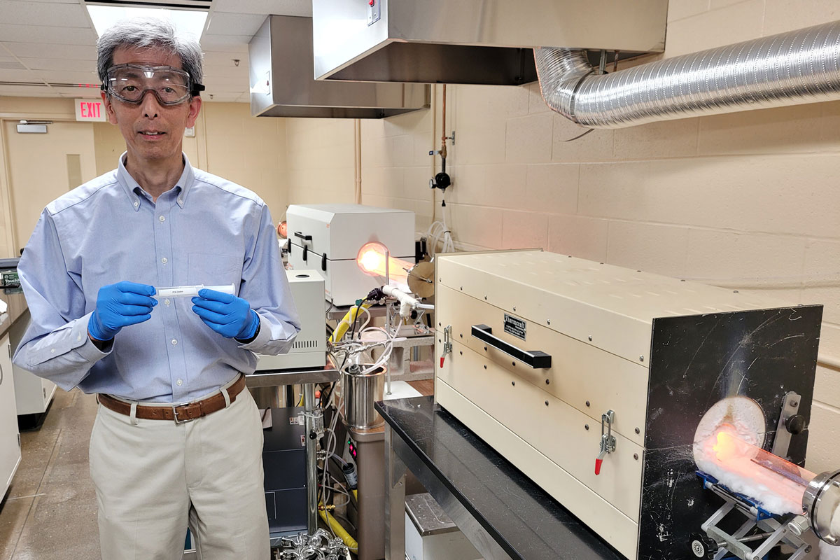 Principal environmental chemist Tak Yamada holds a PFAS sample for testing.