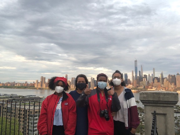 Tiffany and her daughters against NYC skyline